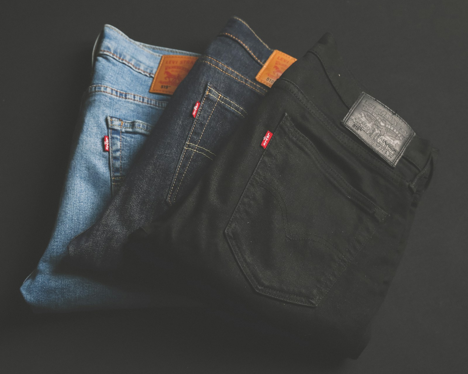 Faded blue and black denim arranged together